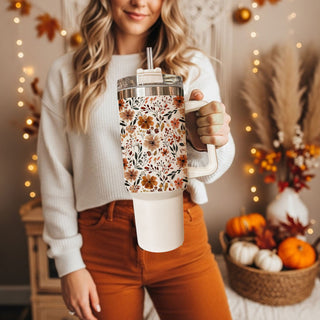 Stay cozy all autumn long with this beautiful floral fall 40oz tumbler featuring a warm neutral flower pattern and insulated stainless steel design. Perfect for iced coffee, tea, water, or seasonal drinks, this handled tumbler keeps beverages hot or cold for hours and includes a reusable straw with spill-resistant lid. 