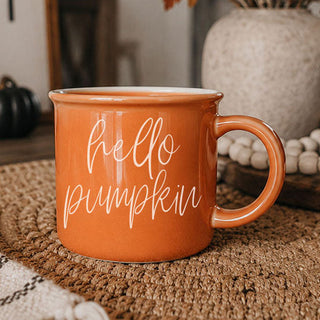 pumpkin colored coffee cup and donut
fall inspired mug with warm brown tones
orange ceramic drinkware for seasonal lattes
autumn shelf styling with orange coffee cup