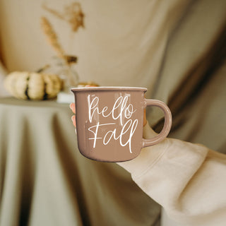 hello fall autumn drinkware in cozy living room
hello fall mug with gold spoon and saucer
hello fall mug on window sill with rainy day view
