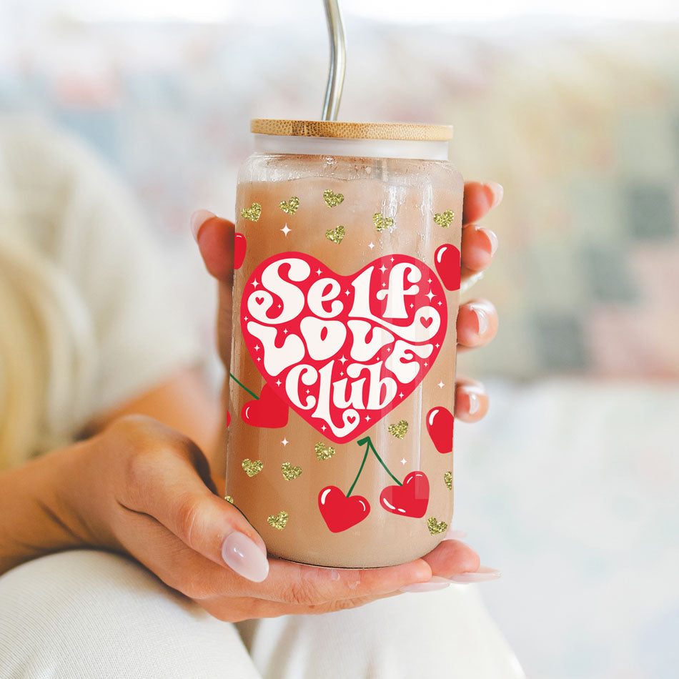 20oz glass cups with bamboo lid and glass straw featuring red hearts and gold glitter, a perfect self love gift for women.
Women’s empowerment gifts with 20oz glass cups featuring Self Love Club, red hearts, and cherry graphics.