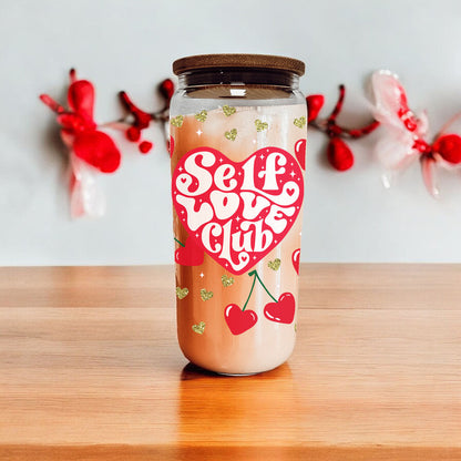 Self Love Club 20oz glass cups with bamboo lid and glass straw, a perfect inspirational gift for women’s self growth.
20oz glass cups with bamboo lid and glass straw featuring gold glitter hearts and Self Love Club, ideal for empowering gifts.