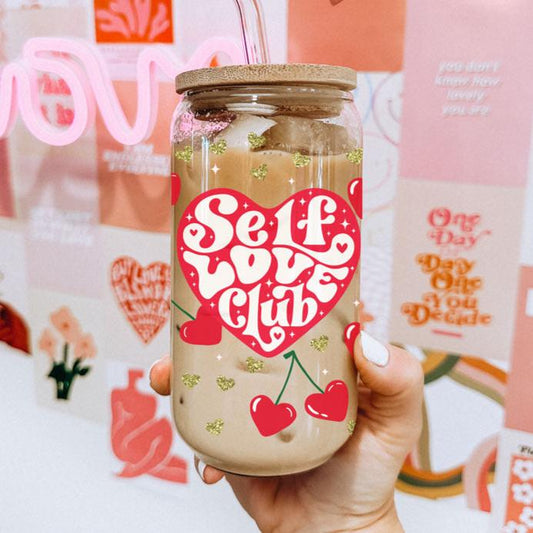 Self love club glass cup 20oz. 
20oz glass cups with bamboo lid and glass straw featuring "Self Love Club" and red heart cherry graphics.
Retro "Self Love Club" 20oz glass cups with bamboo lid, glass straw, and gold glitter hearts.