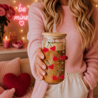 Wholesale 20oz glass cups with bamboo lid and glass straw featuring Self Love Club design, red heart, and cherry graphics.
Self Love Club 20oz glass cups with bamboo lid, glass straw, and gold glitter hearts for an empowering Valentine’s gift.
