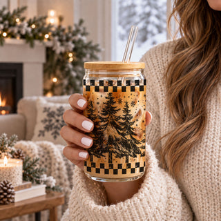 Festive 17oz Christmas glass tumbler with retro evergreen tree wrap design, bamboo-style lid, and reusable straw. Perfect for iced coffee, cold brew, holiday drinks, and Christmas gift giving.